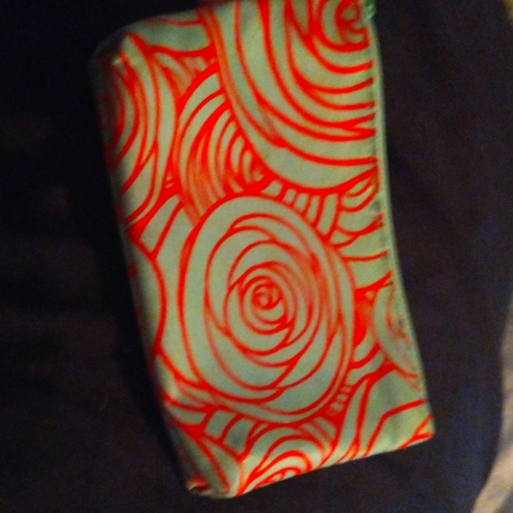 A hand bag it's green blue and orange
